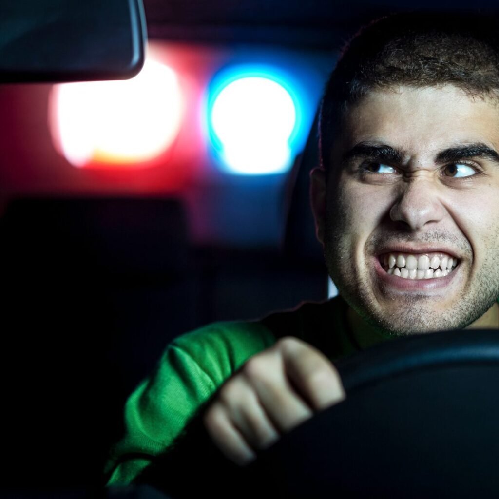 Young man behind the wheel looking overly excited